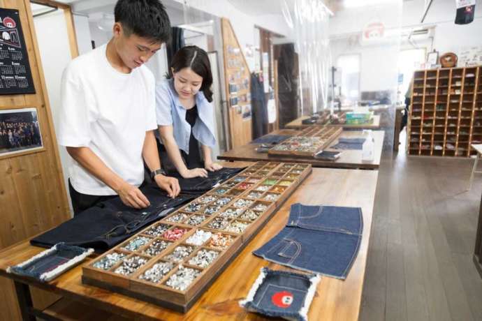 岡山県倉敷市にある「ベティスミス ジーンズミュージアム&ヴィレッジ」のジーンズ作り体験でのパーツ選びの様子