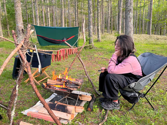 千代田湖キャンプ場で焚き火を使って調理する女性
