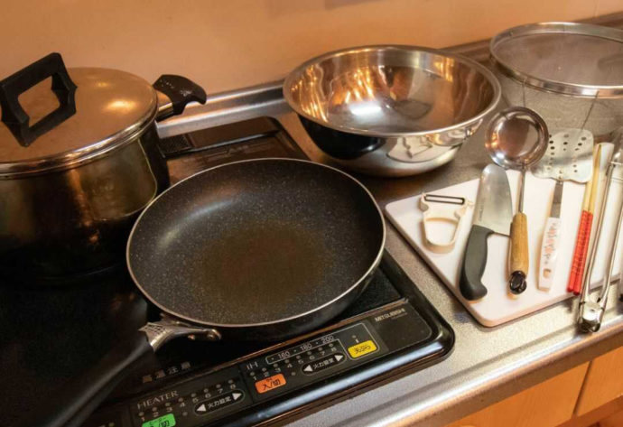 一位の宿の和風コテージの調理台やコンロに置かれた複数の調理器具