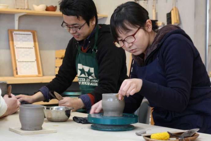 福岡県春日市にある「陶芸教室やわら木」で手回しろくろを体験しているカップル