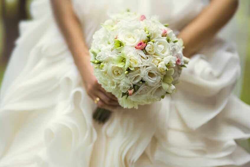 白いバラのブーケを持った花嫁の写真